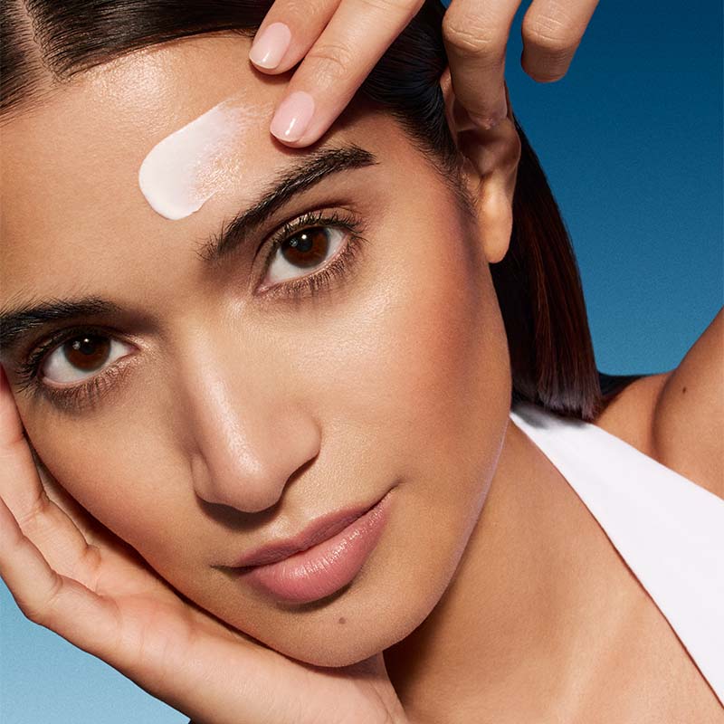 a woman applying sunscreen